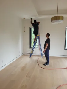 Encore Duct Cleaning technician using drop cloths to protect clean home flooring.