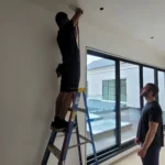 Applying antimicrobial sanitizing fog to residential HVAC air ducts.
